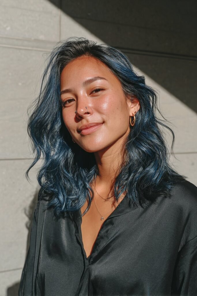 Medium close-up portrait featuring midnight blue waves with silver face-framing highlights