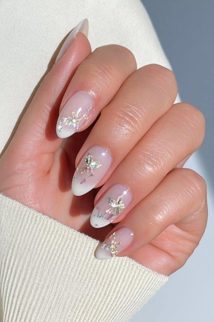 Short round milky beige Thanksgiving nails with delicate gems accents.
