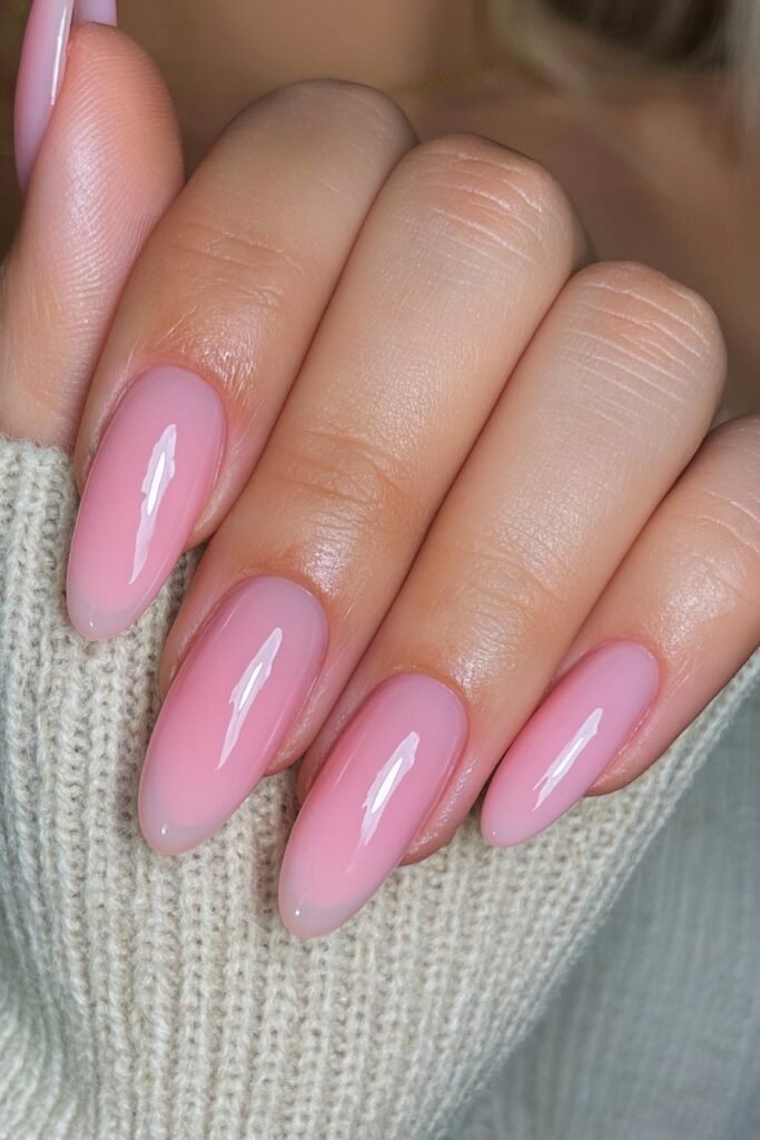 Sheer milky pink almond nails with a clean glazed finish.