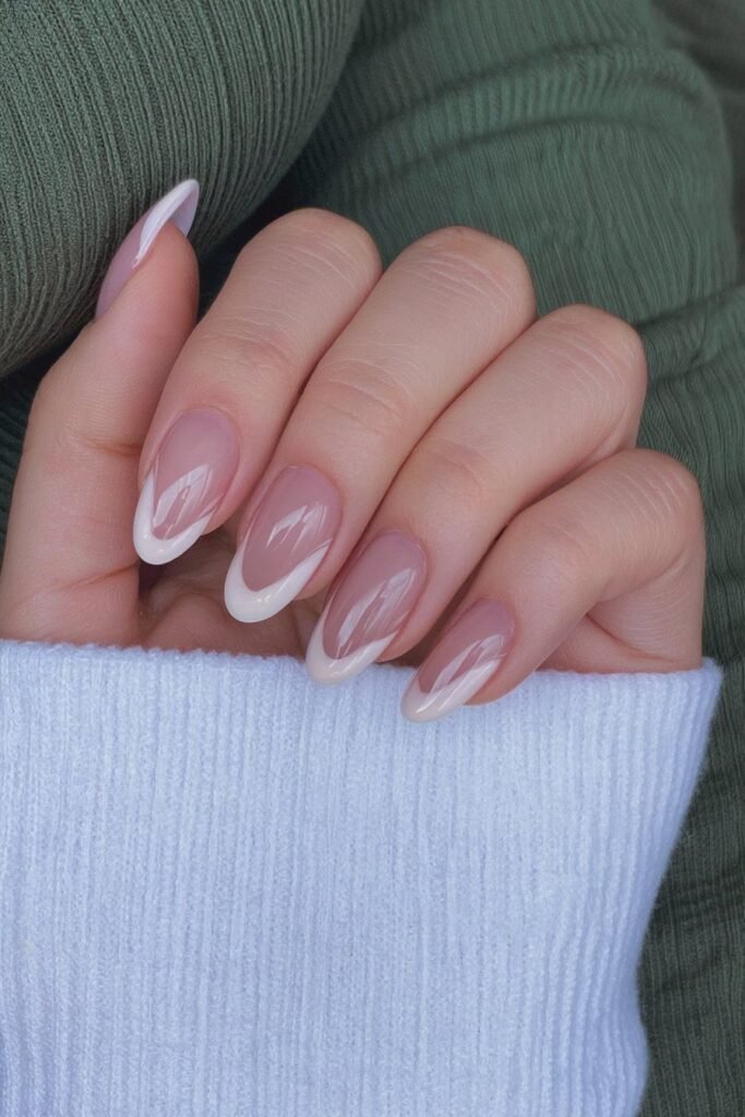 Short milky white tips nails with glossy accents.