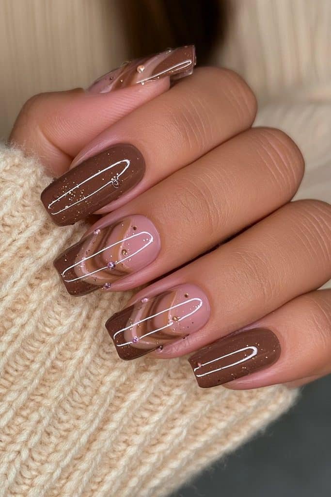 Short oval nails with chocolate brown, caramel, cream, and swirl accents