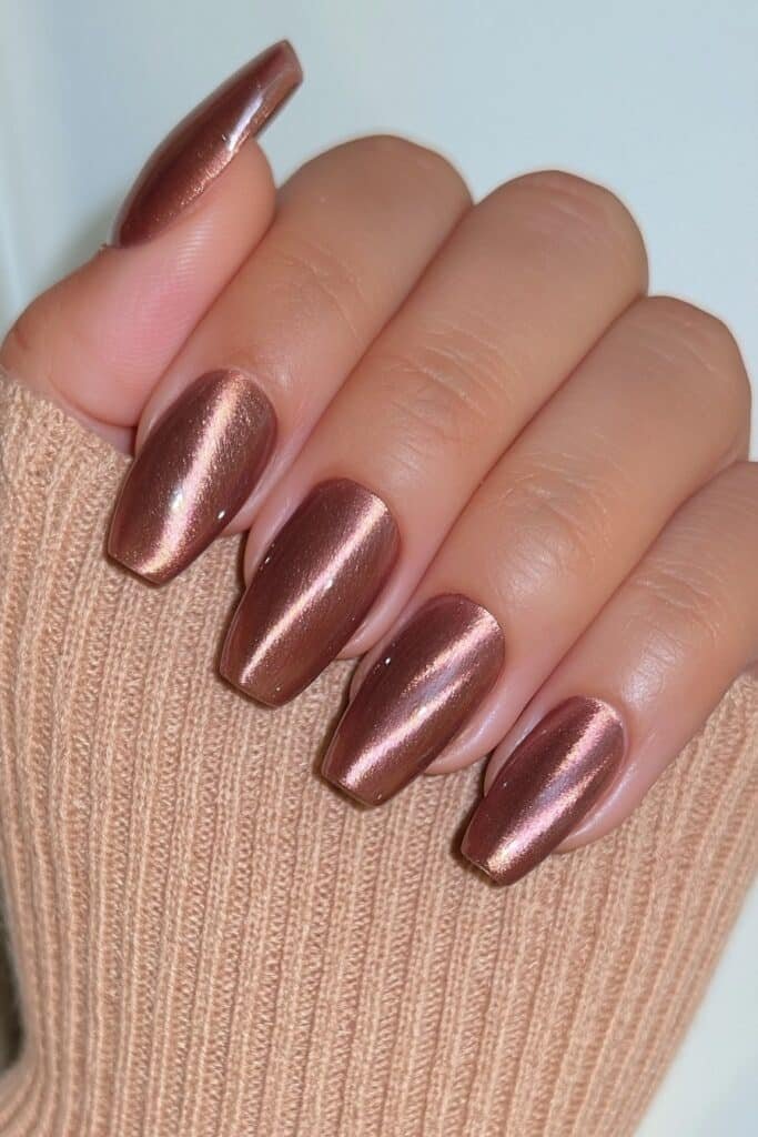 Short squoval mocha brown magnetic cat-eye nails with a dimensional luminous streak.