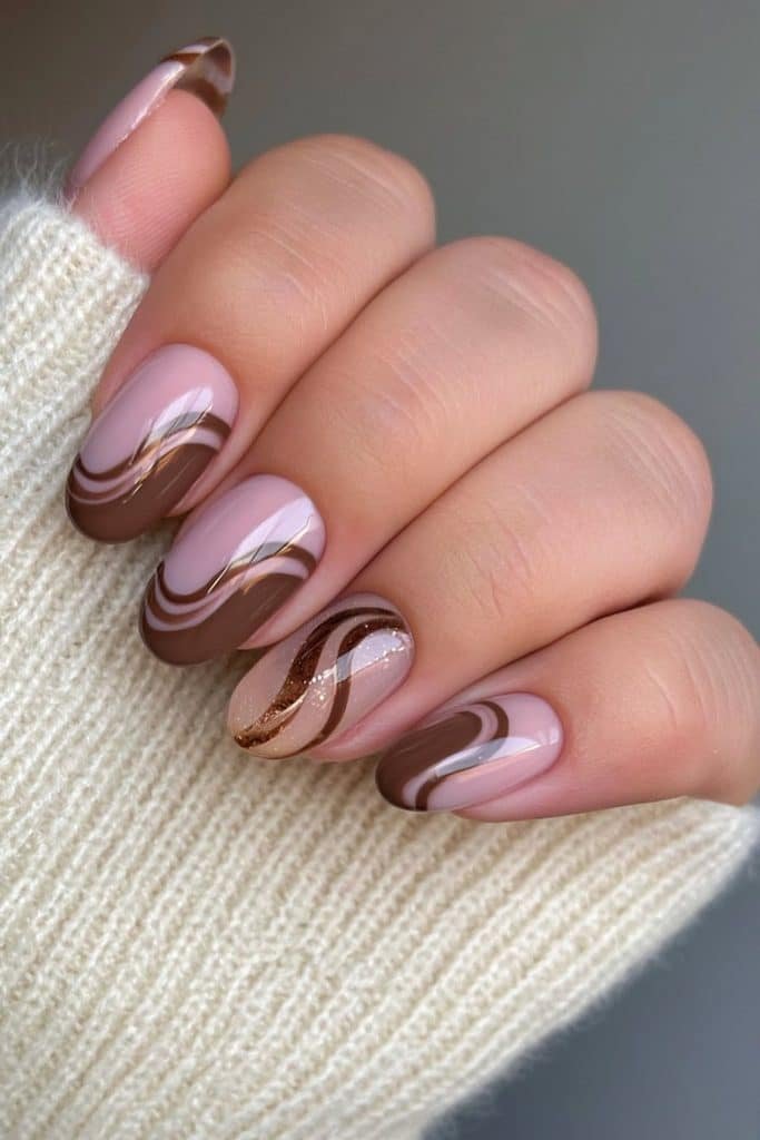 Short round nails with chocolate brown curved lines and negative space