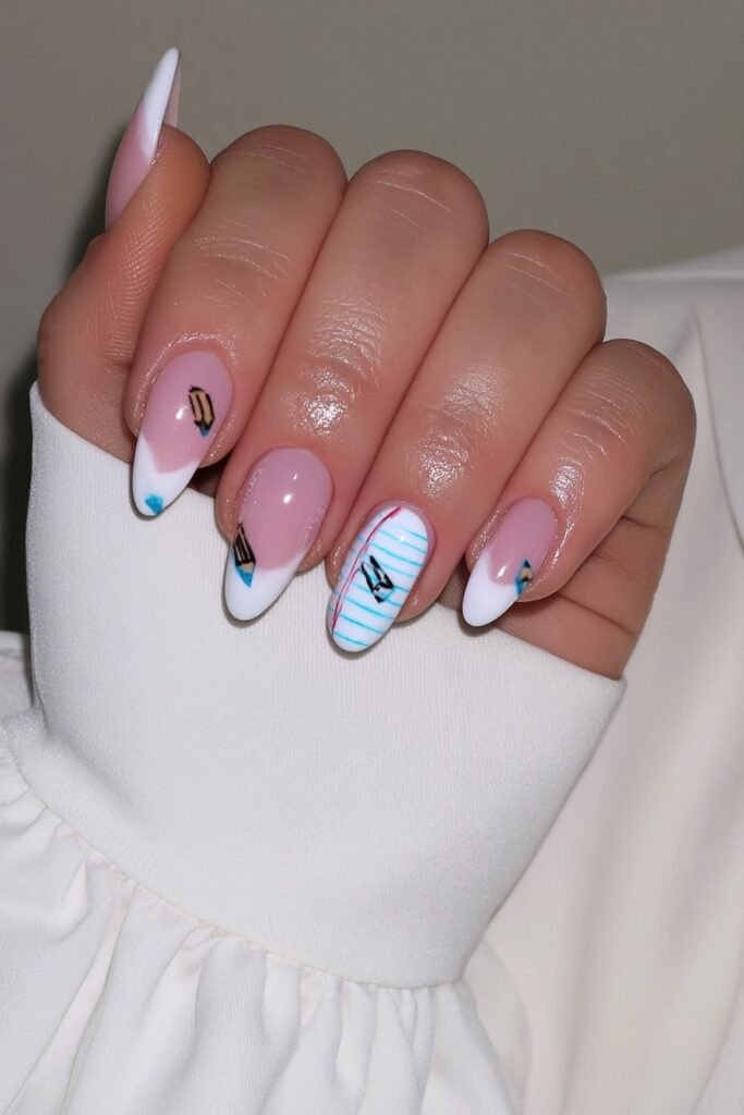 Pencil-themed nails with a notebook paper accent design.