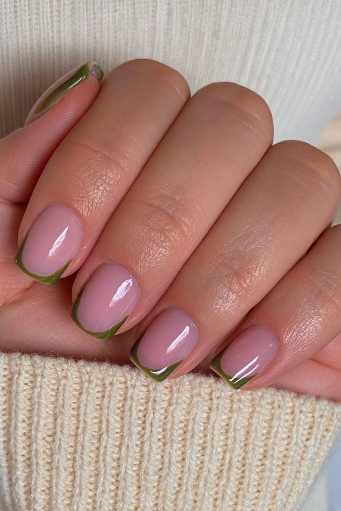 Short nude nails with olive green French tips.