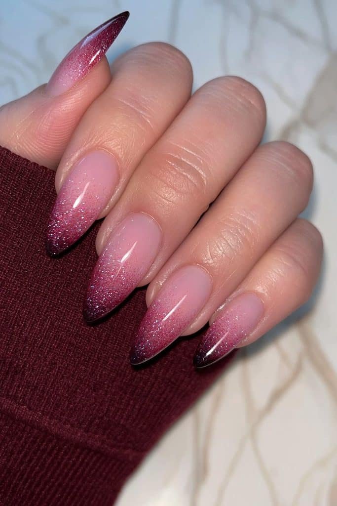 Short almond nails with a seamless oxblood red to deep black ombré.