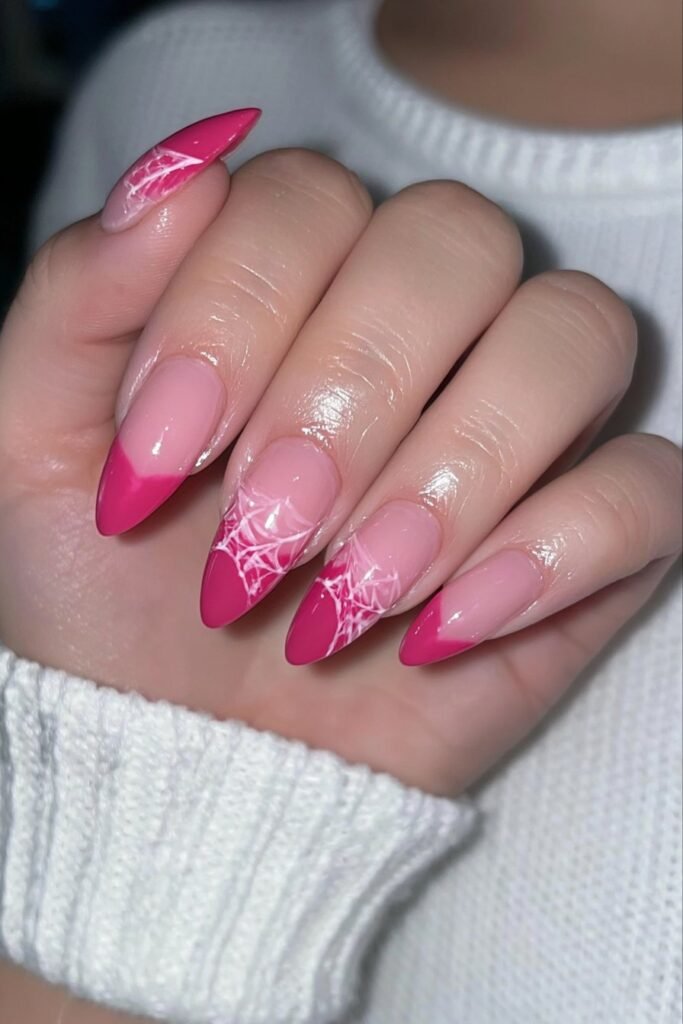 Pastel pink chrome nails with subtle spider web details.