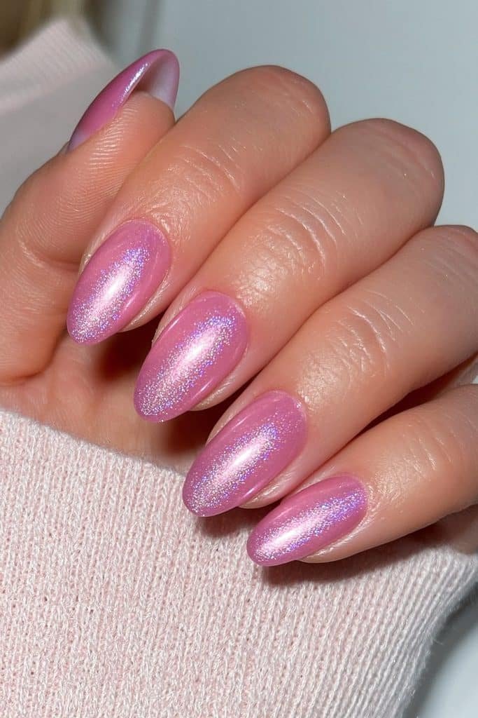 Short round nails in pastel pink velvet with delicate pearlescent shimmer.