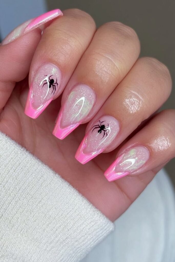Pink chrome French tips with tiny spider silhouettes.