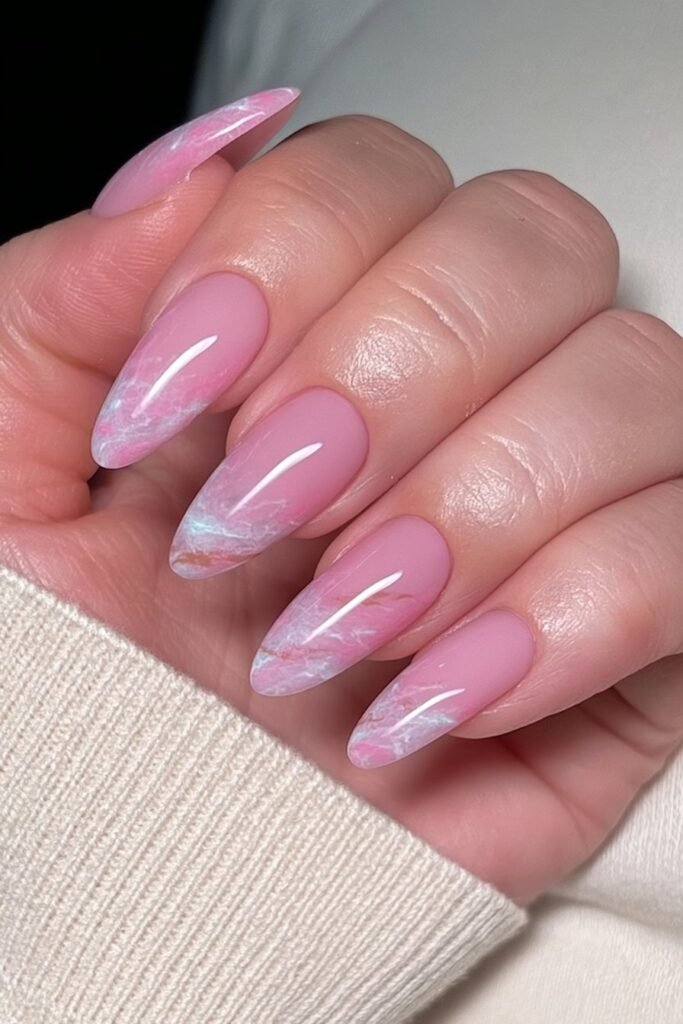 Blush pink marble almond nails with delicate white veining.