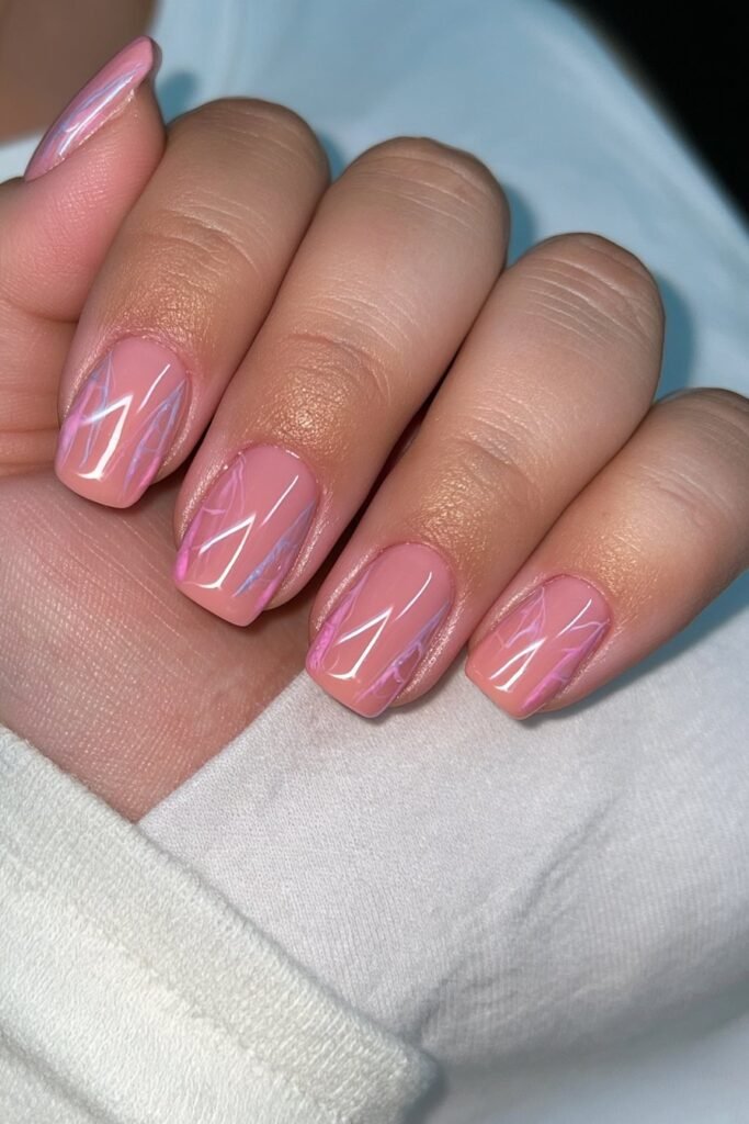Short natural pink nails with minimalist spider web accents.