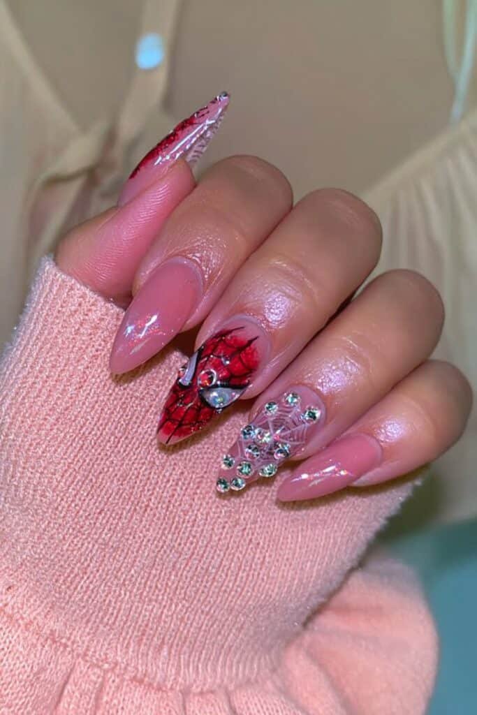 Pink spider web nails with sparkling rhinestones.