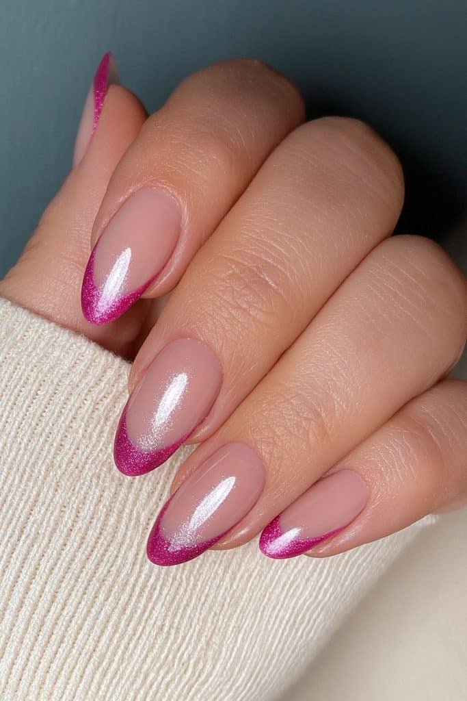 Short almond nails with soft pink velvet magnetic French tips over nude bases.