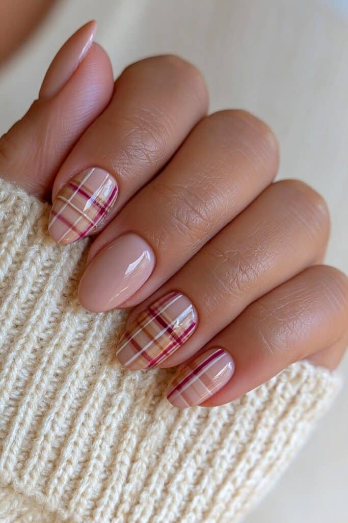 Warm nude nails with brown, burgundy, and beige autumn plaid.