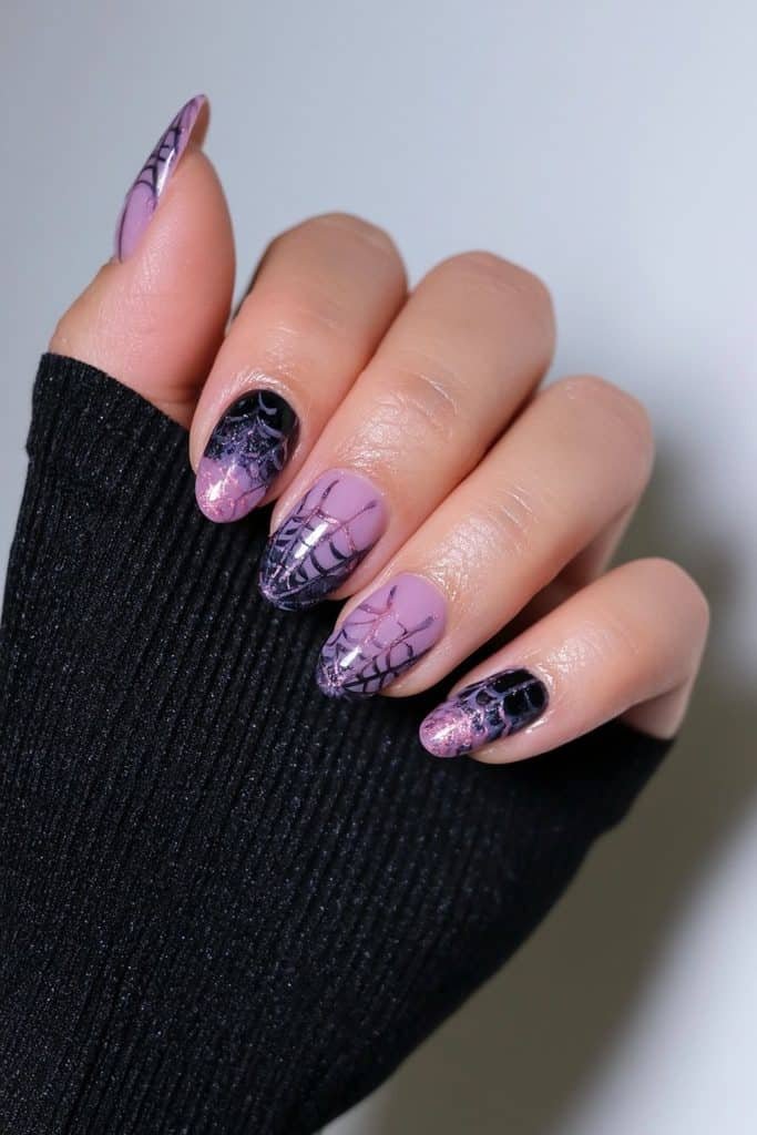 Short purple and black nails with delicate contrasting spiderweb artwork.