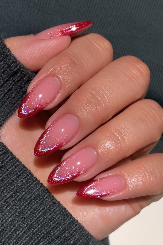 Short scarlet almond nails with subtle holographic shimmer and glossy shine.