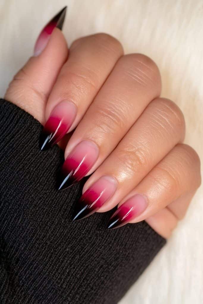 Short almond nails with a dramatic scarlet red to deep black ombré.
