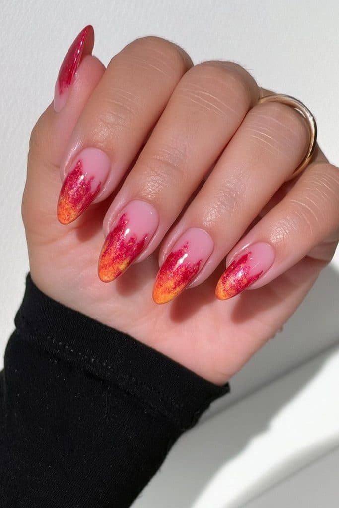 Short almond nails with a warm scarlet-red to burnt-orange ombré.