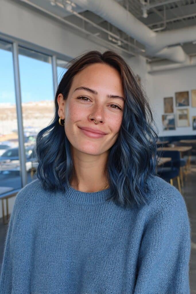 Medium close-up portrait highlighting sapphire roots blended into glossy blue waves