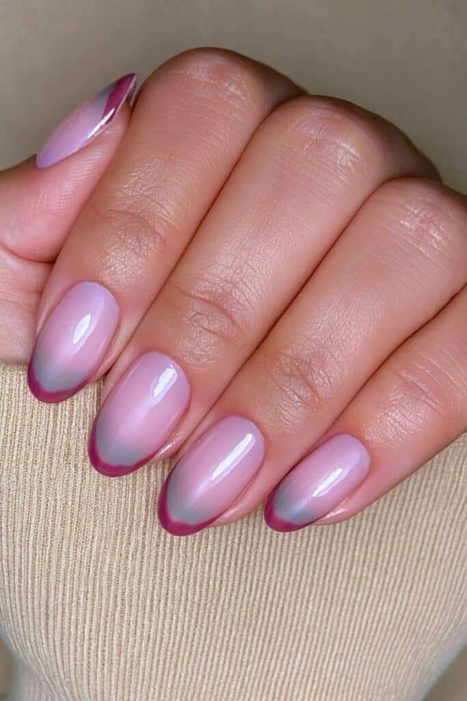 Short nude nails with cranberry scalloped French tips.