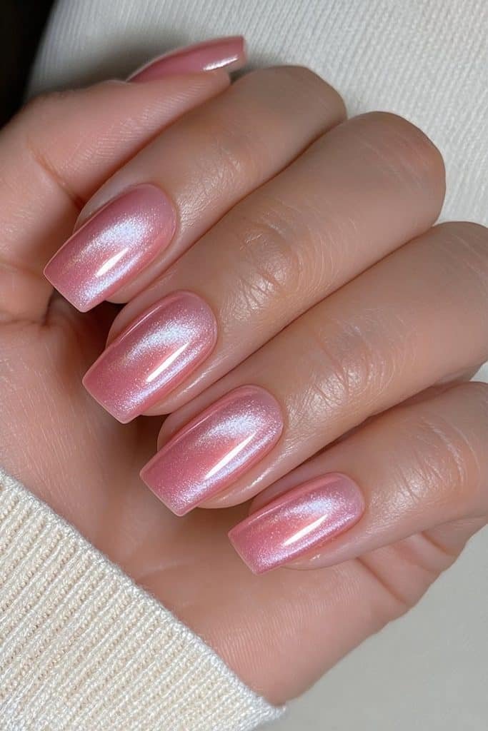 Short squoval nails in sheer neutral pink with a pearlescent glazed donut finish.