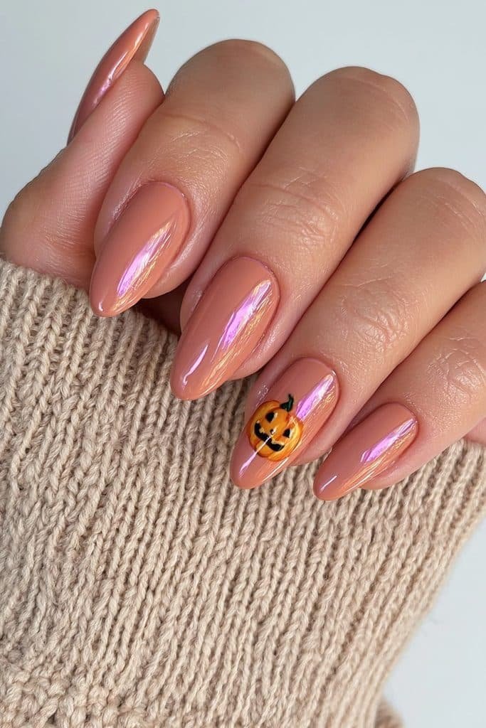 Short orange almond nails with one tiny pumpkin-face accent.