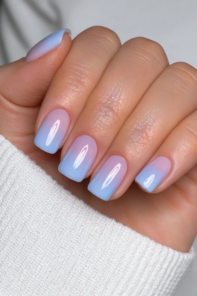 Short sky blue nails with a soft glossy finish.