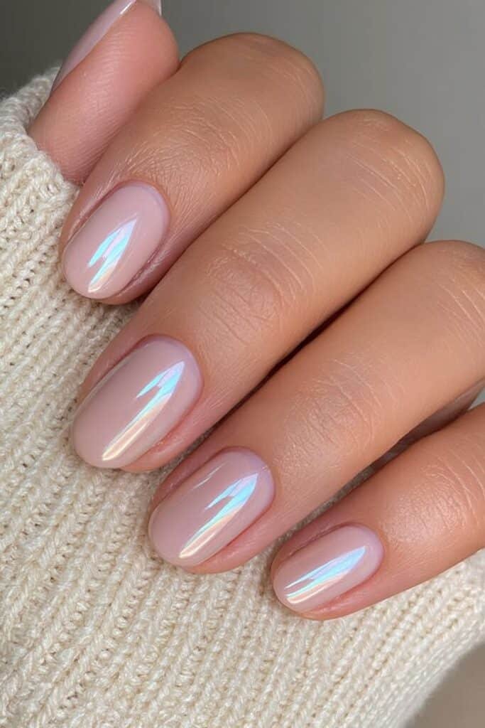 Short champagne chrome nails with a soft reflective finish.