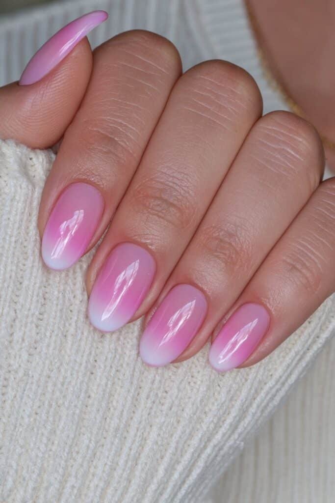 Short blush pink to milky white ombré nails.