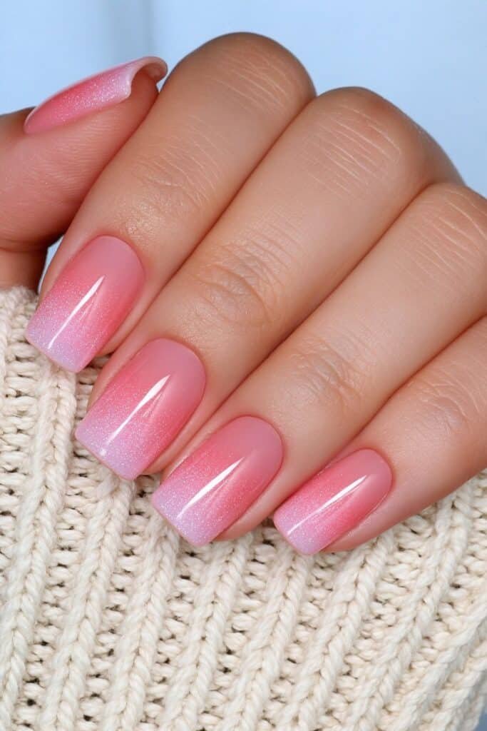 Short coral nails with a glossy late-summer finish.