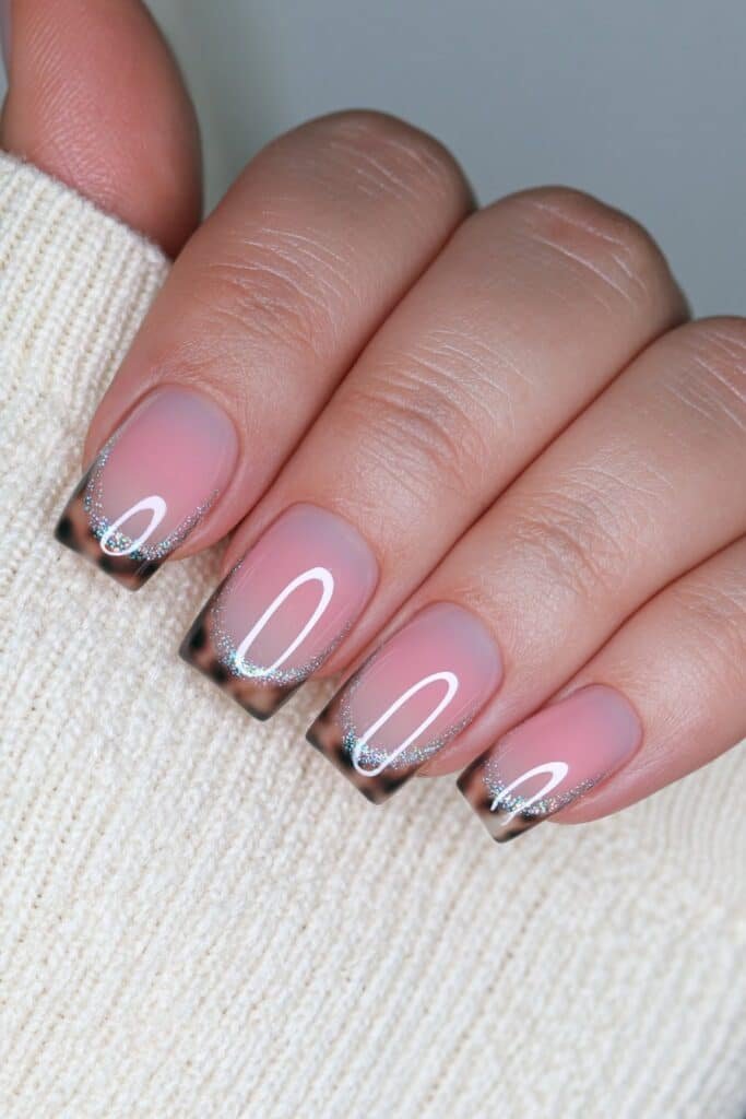 Short nude nails with warm tortoise shell tips.