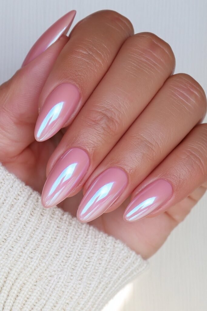 Creamy vanilla chrome almond nails with a luminous glazed finish.