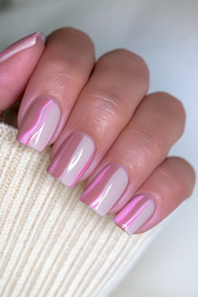 Short caramel nails with creamy beige marble swirls.
