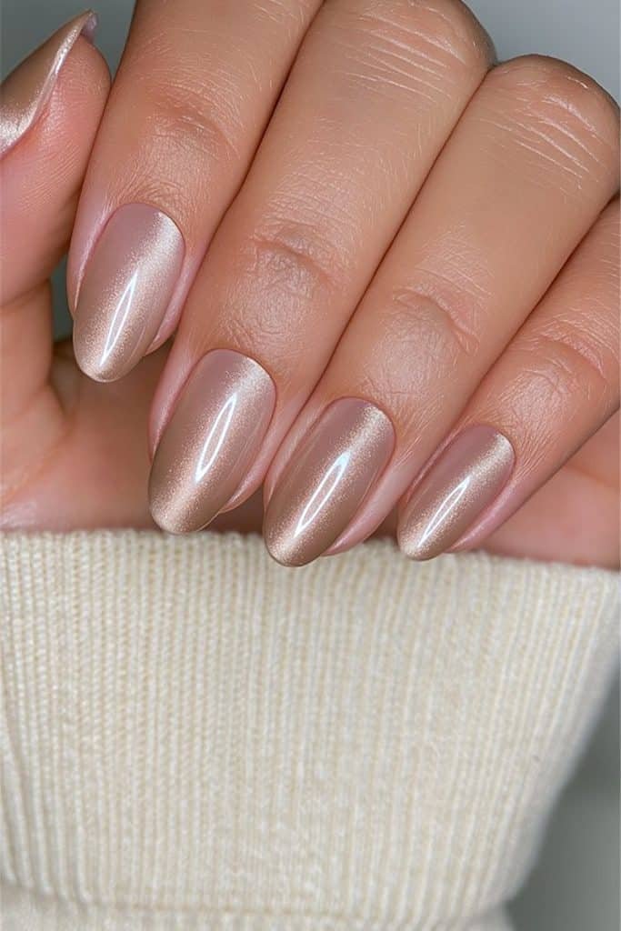 Short round nails in warm nude velvet with delicate champagne shimmer.