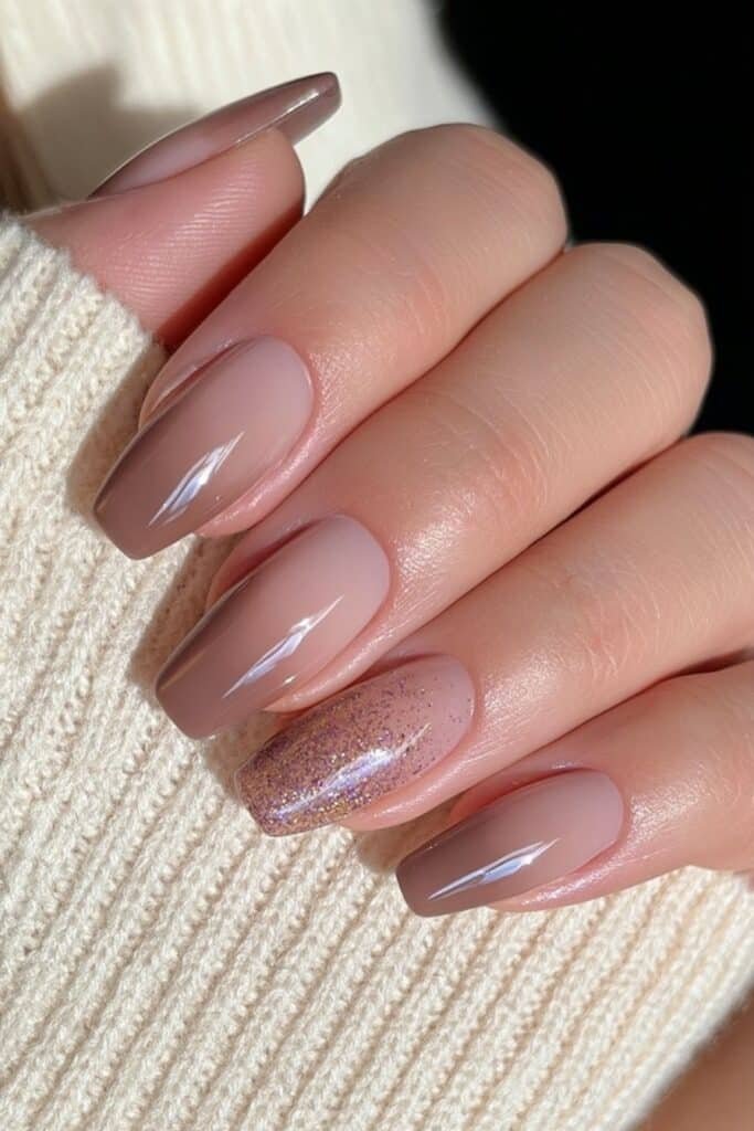 Short squoval warm taupe-brown nails with creamy neutral coverage and glossy shine.