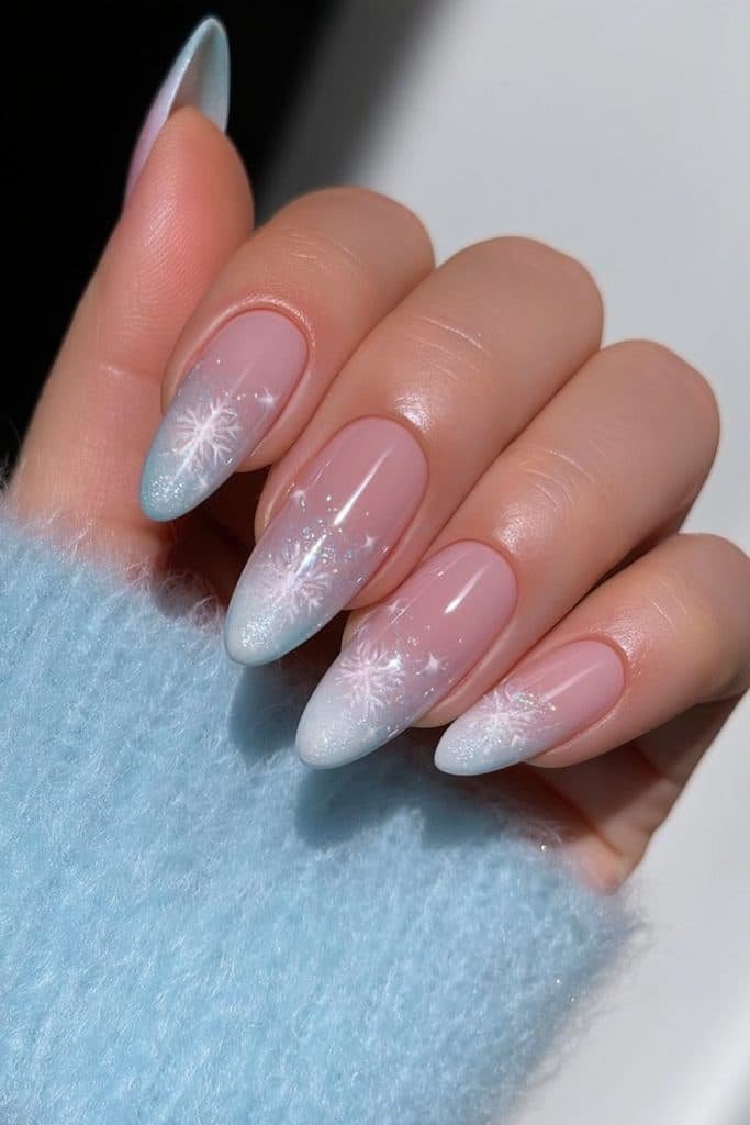 Icy blue ombré nails with delicate snowflakes