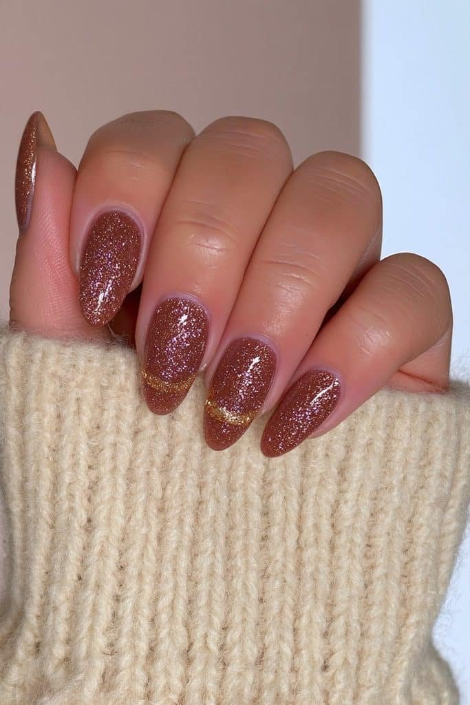 Chocolate brown nails with elegant gold glitter accents