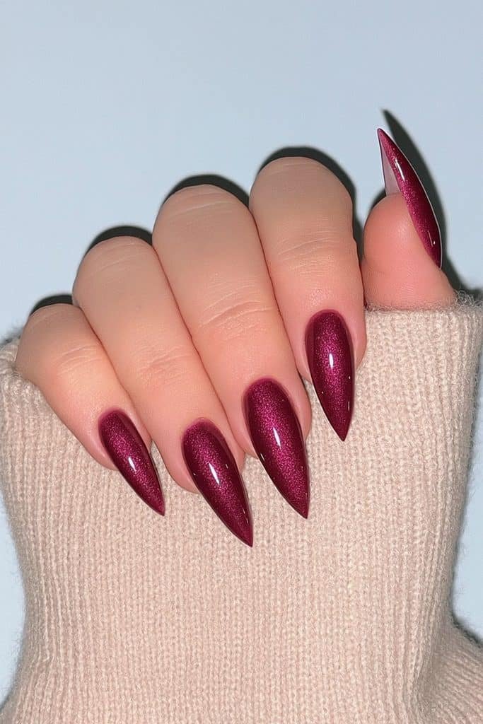 Deep burgundy wine stiletto nails with glass-like shine