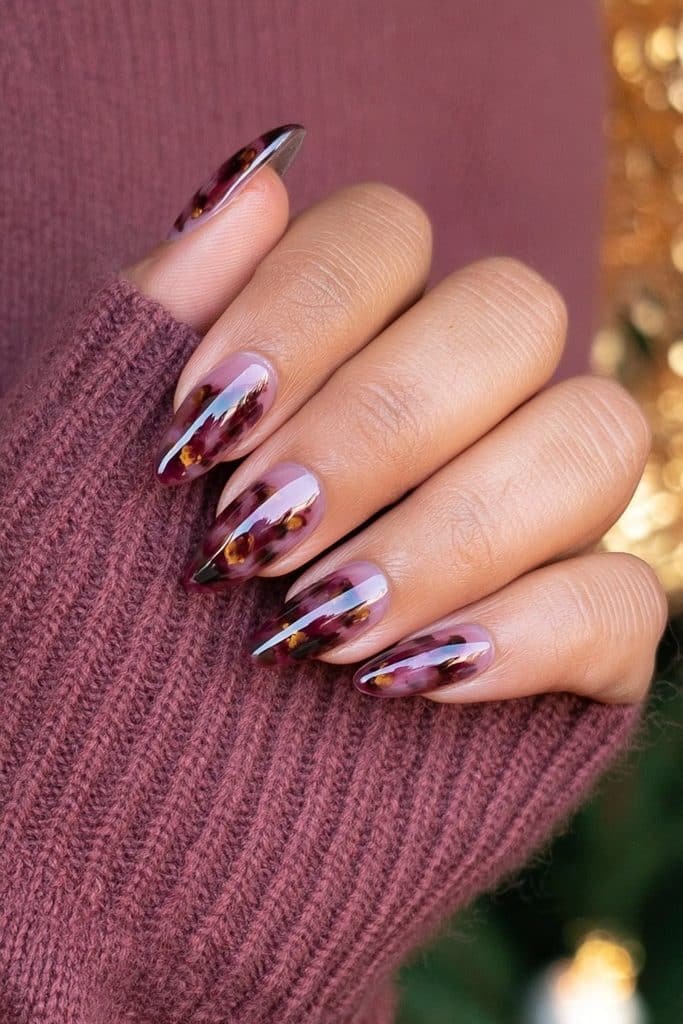 Burgundy tortoiseshell nails with amber and chestnut tones