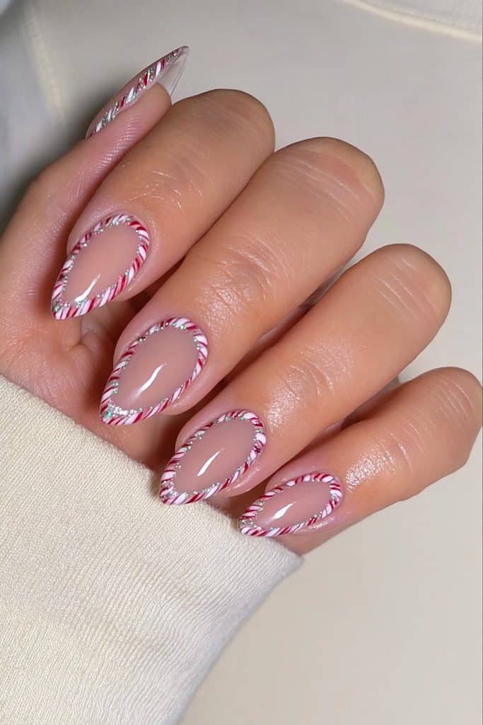 Nude nails with delicate red and white candy cane borders