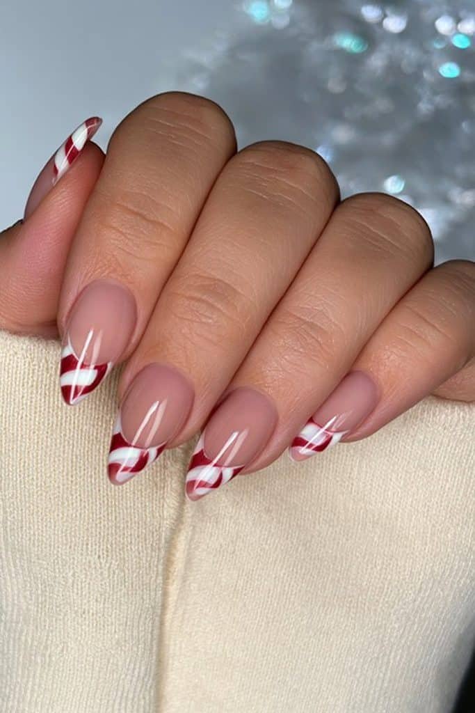 Red and white candy cane French tip almond nails