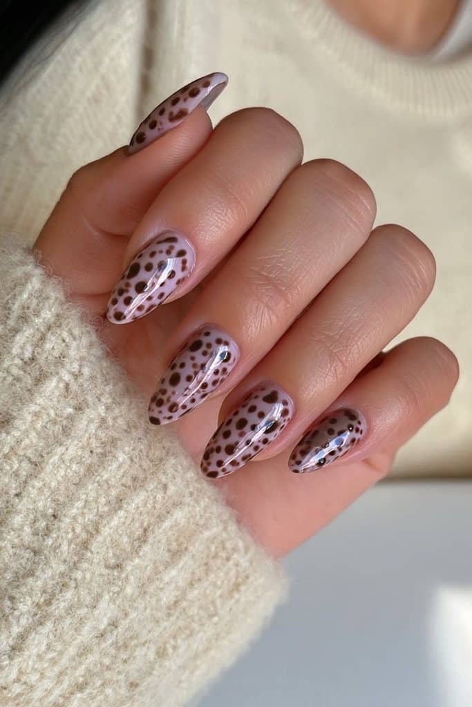 Creamy nude nails with chocolate polka dots