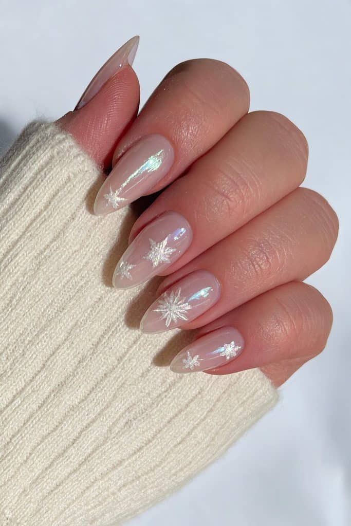 Milky chrome nails with reflective snowflake accents