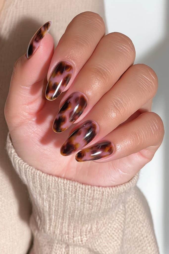 Classic amber tortoiseshell almond nails with caramel and brown tones
