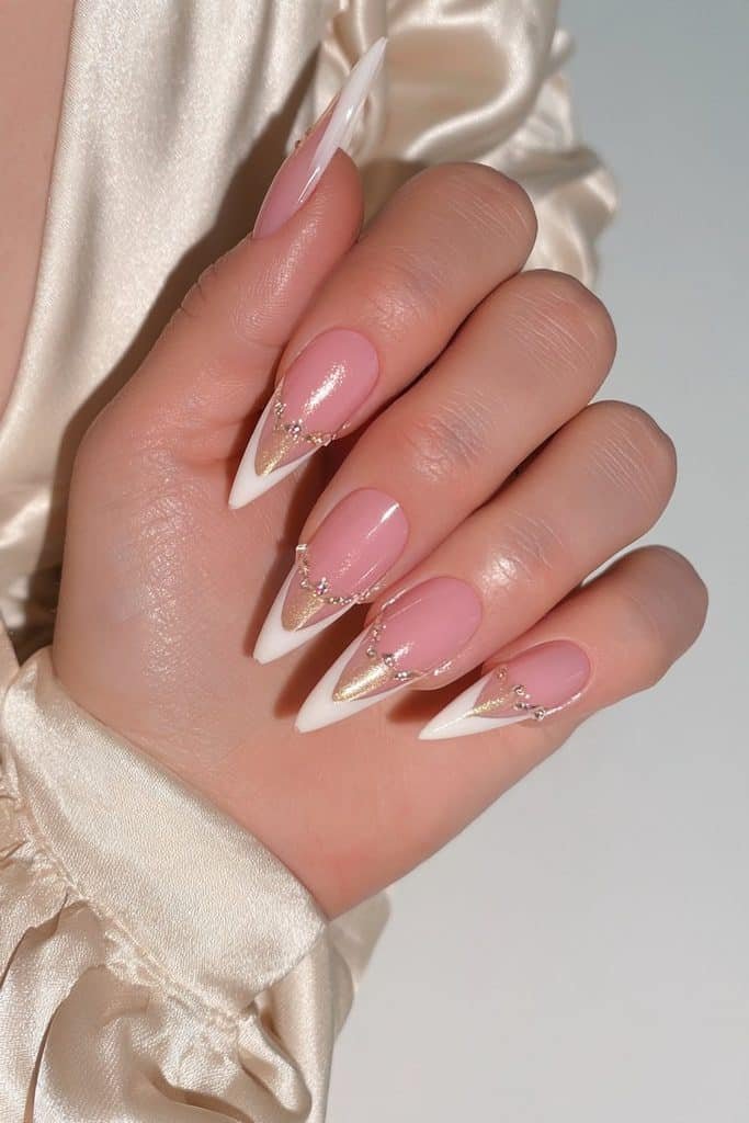Nude-pink stiletto nails with champagne shimmer and crystals