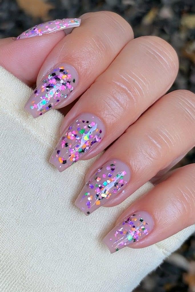 Sheer nude coffin nails with colorful confetti accents