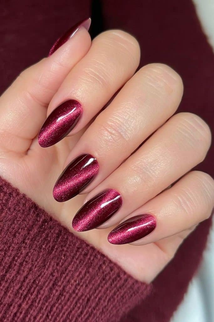 Cranberry cat-eye nails with luminous highlights