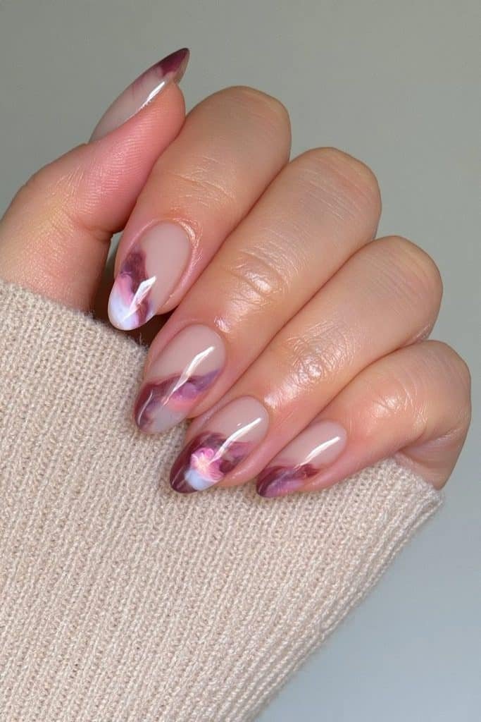 Nude nails with cranberry marble swirls