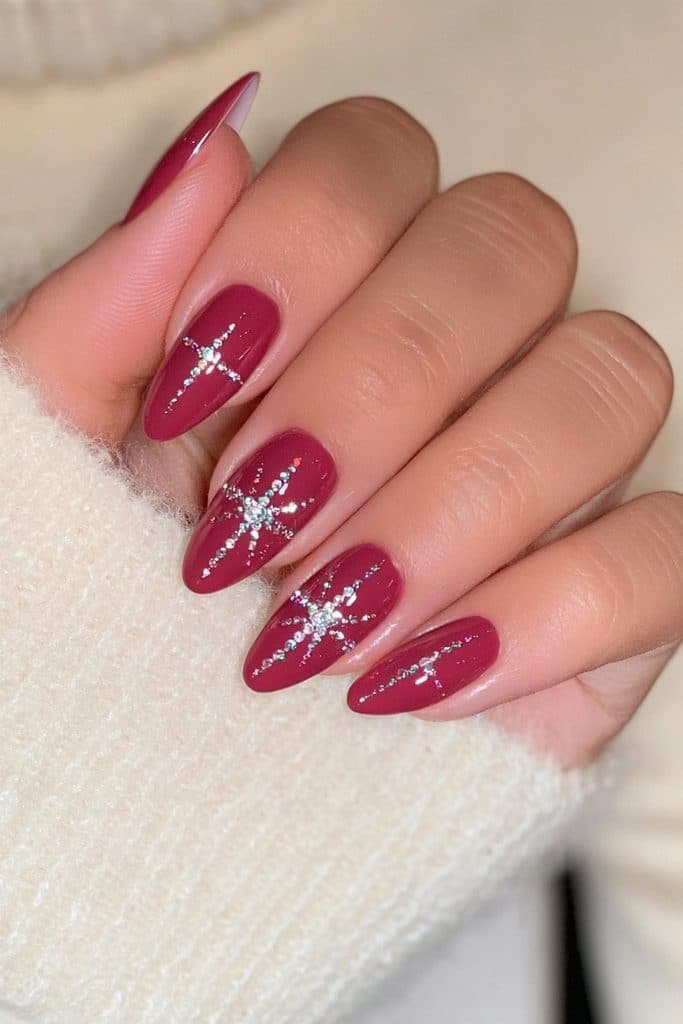 Glossy cranberry nails with delicate rhinestone accents