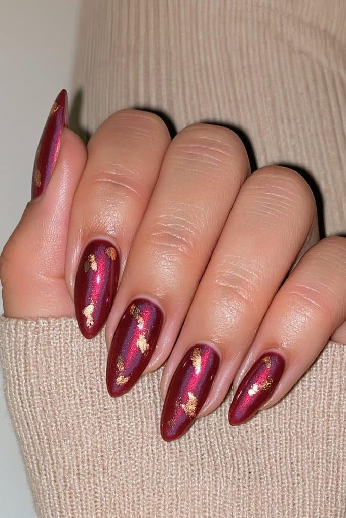 Glossy cranberry nails with gold foil accents